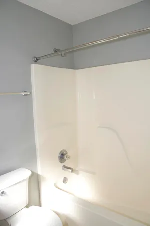 a bathroom with a bathtub and a toilet