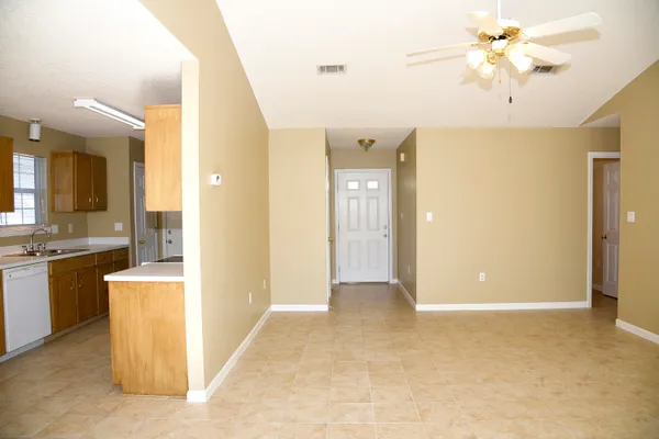 a view of a kitchen with a sink and a refrigerator
