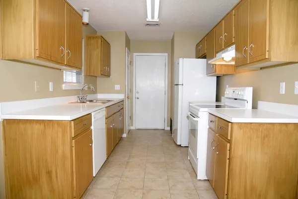 a kitchen with stainless steel appliances a stove a sink and a refrigerator
