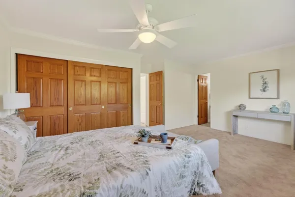 a bedroom with a large bed dresser and mirror