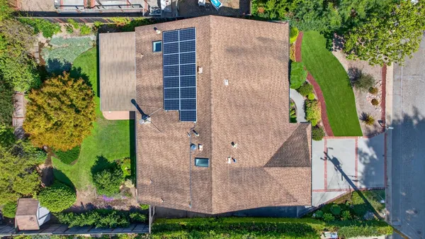 an aerial view of a house with a yard