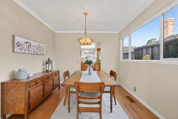 a dining room with furniture and a chandelier