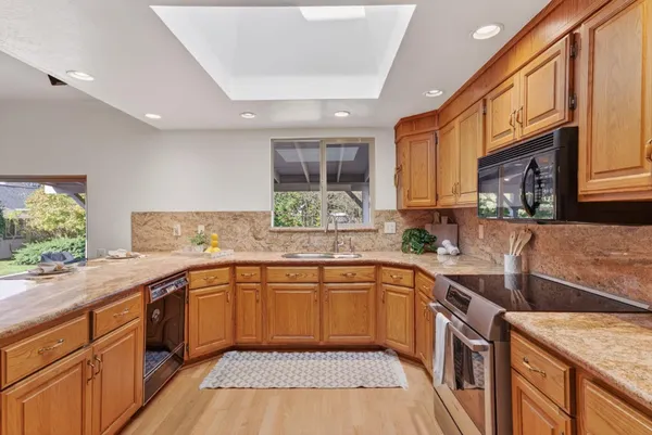 a kitchen with a sink stove and cabinets