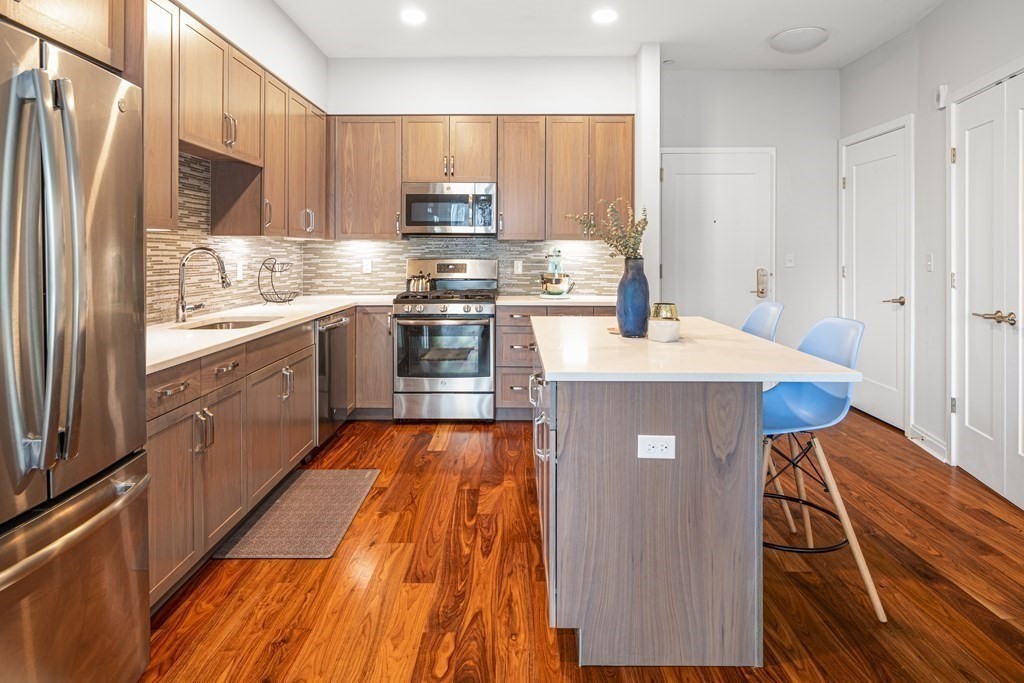 3531 Washington Street, Unit 206 Boston, MA 02130 - Photo 3 of 18 a kitchen with stainless steel appliances a refrigerator sink and microwave