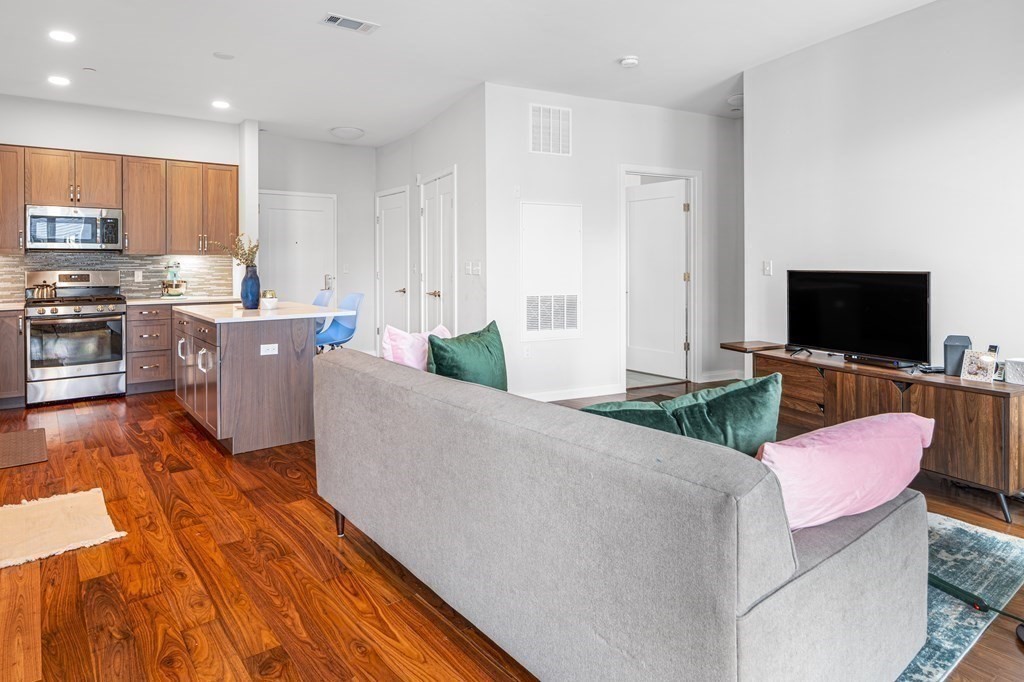 3531 Washington Street, Unit 206 Boston, MA 02130 - Photo 6 of 18 a living room with stainless steel appliances furniture and a flat screen tv