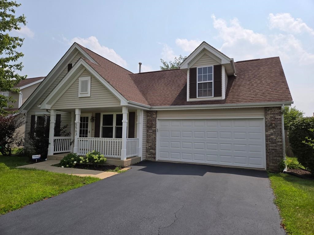 5563 Stockton Drive Rockford, IL 61109 - Photo 1 of 29 a front view of a house with a yard and garage