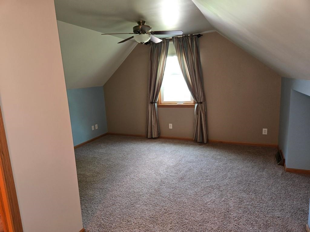 5563 Stockton Drive Rockford, IL 61109 - Photo 15 of 29 an empty room with a ceiling fan and carpet