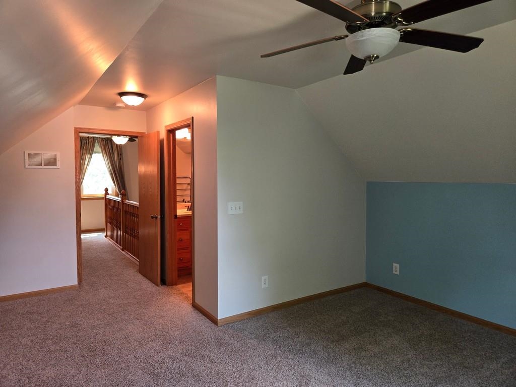 5563 Stockton Drive Rockford, IL 61109 - Photo 16 of 29 an empty room with a mirror and a ceiling fan