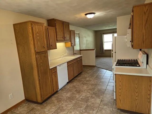a kitchen with stainless steel appliances a refrigerator and a stove
