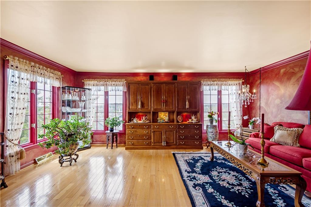 103 Yorktown Road Canonsburg, PA 15317 - Photo 3 of 25 Living Room with hardwood floors, crown molding and windows galore.