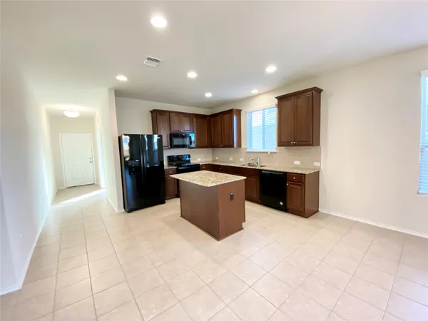 an empty room with a window and a ceiling fan
