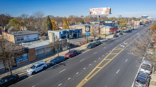 a living room with stainless steel appliances furniture and a kitchen view