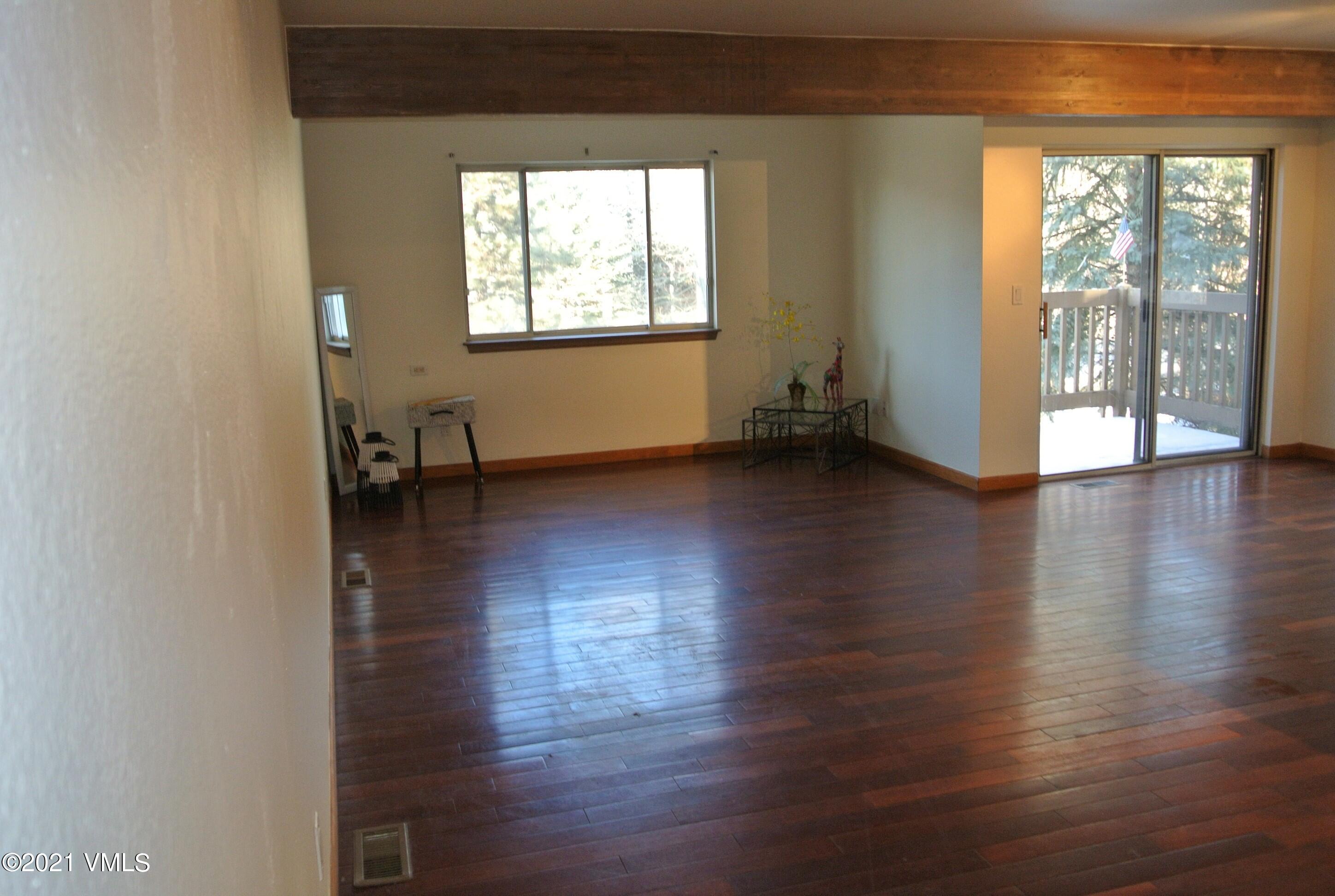170 Eagle Road, Unit C Avon, CO 81620 - Photo 2 of 16 an empty room with wooden floor and a window
