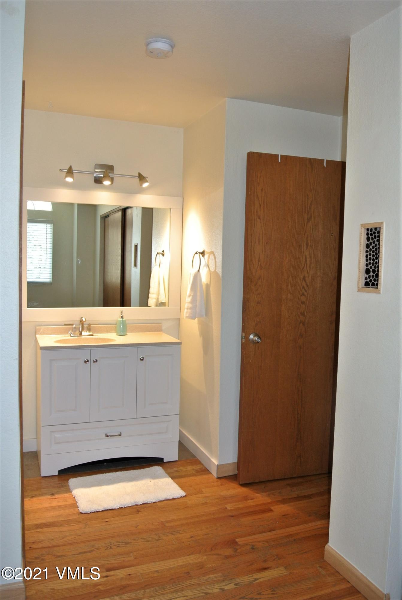 170 Eagle Road, Unit C Avon, CO 81620 - Photo 7 of 16 a view of a bathroom with mirror and sink