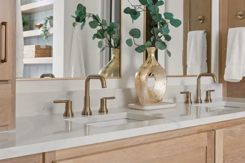 a bathroom sink with a granite countertop mirror and vanity
