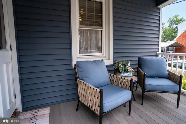 a view of a patio with a table and chairs