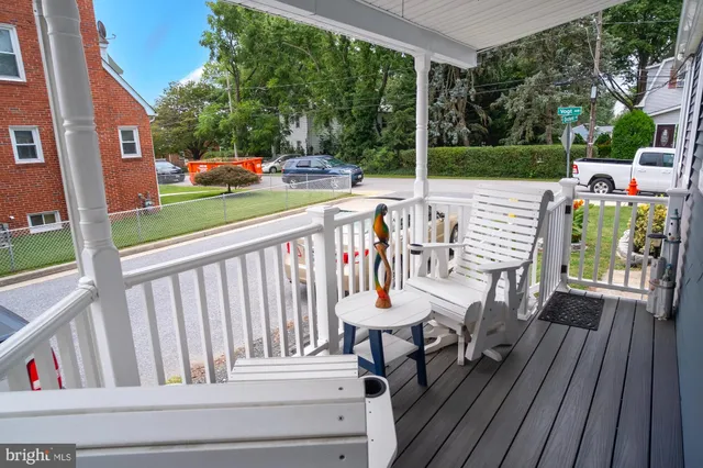 a view of balcony with wooden floor and outdoor seating
