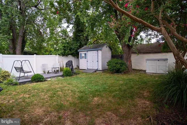 a view of a chair and table in the backyard