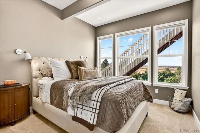 a front view of a house with a yard and potted plants