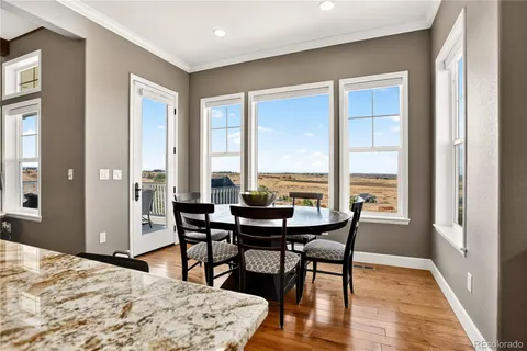 a living room with furniture fireplace and a large window