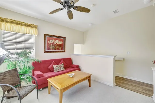 a living room with furniture a window and a chandelier