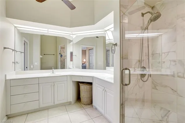 a spacious bathroom with a shower sink and mirror