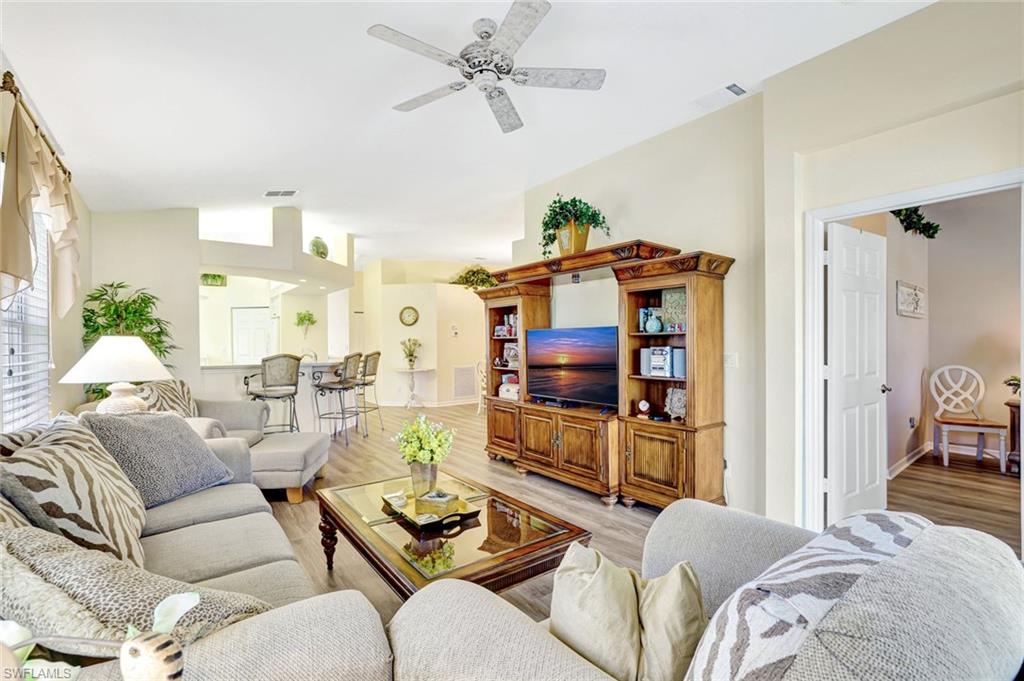 10910 Santa Margherita Road, Unit 204 Estero, FL 34135 - Photo 5 of 42 Living room with wood finished floors, ceiling fan, and vaulted ceiling