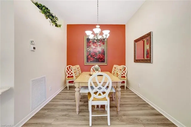 a kitchen with stainless steel appliances granite countertop a refrigerator a sink dishwasher and white cabinets next to a window