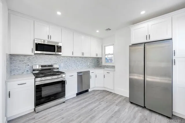 a kitchen with a refrigerator stove and microwave