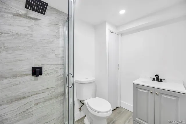 a bathroom with a toilet sink and shower