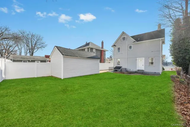 a view of a backyard with potted plants and large tree