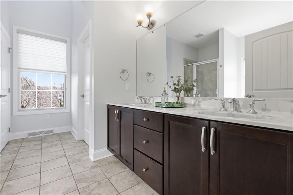 280 Sienna Trail Venetia, PA 15367 - Photo 21 of 37 a bathroom with a double vanity sink a mirror and a bathtub