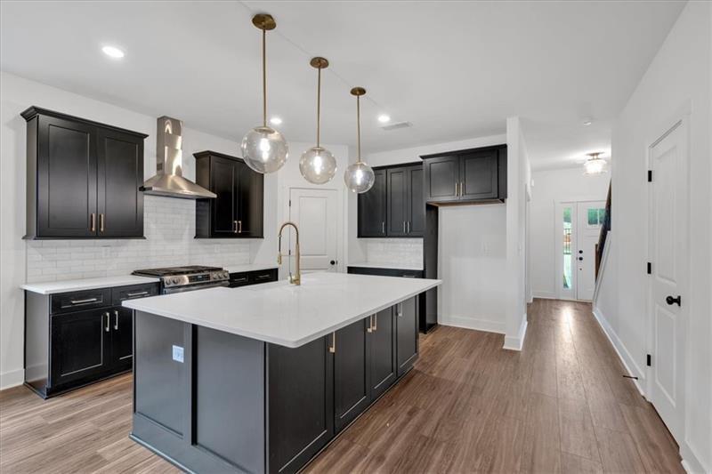 133 Old Alabama Road Southeast Emerson, GA 30137 - Photo 10 of 44 a kitchen with a sink a counter top space stainless steel appliances and wooden floor