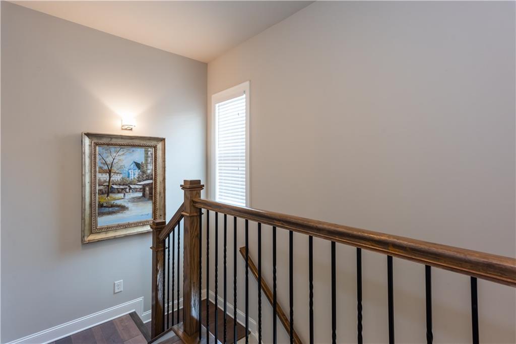5247 Cresslyn Ridge Alpharetta, GA 30005 - Photo 23 of 38 a view of a hallway with wooden floor and a bathroom