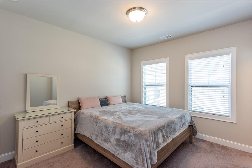 5247 Cresslyn Ridge Alpharetta, GA 30005 - Photo 31 of 38 a bedroom with a bed and a window