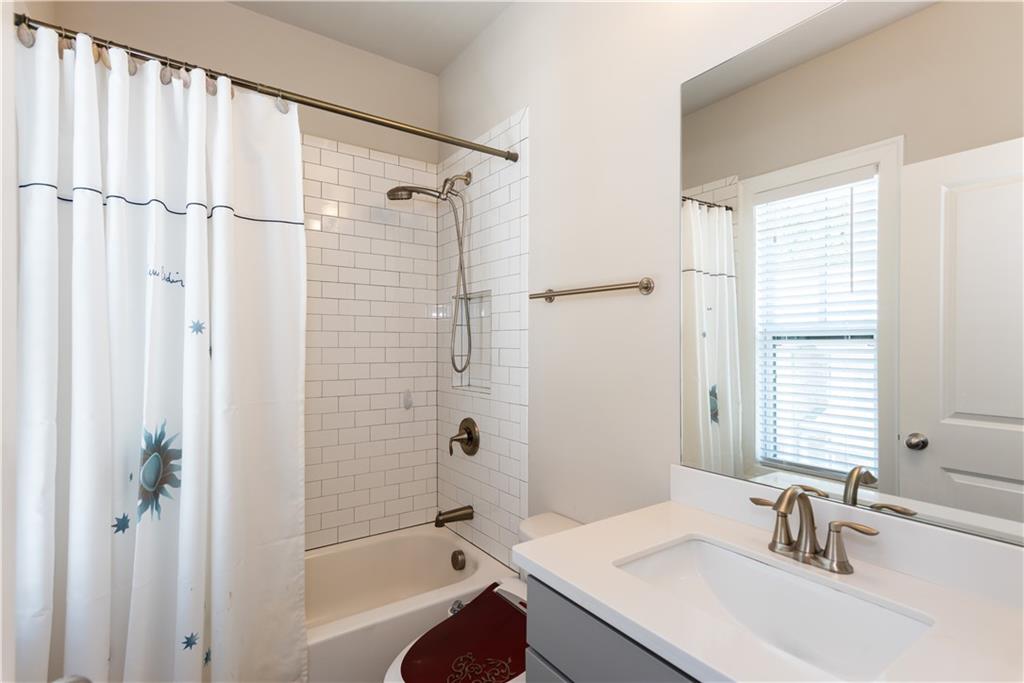5247 Cresslyn Ridge Alpharetta, GA 30005 - Photo 33 of 38 a bathroom with a granite countertop sink a mirror a shower and a bathtub
