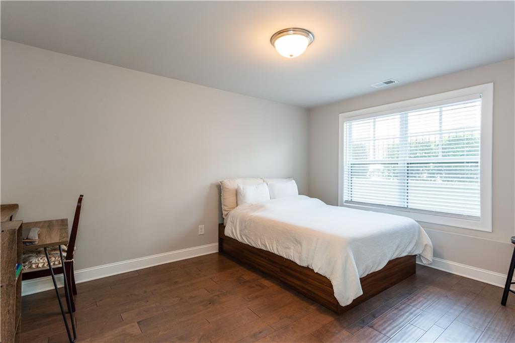 5247 Cresslyn Ridge Alpharetta, GA 30005 - Photo 34 of 38 a bed sitting in a bedroom next to a window