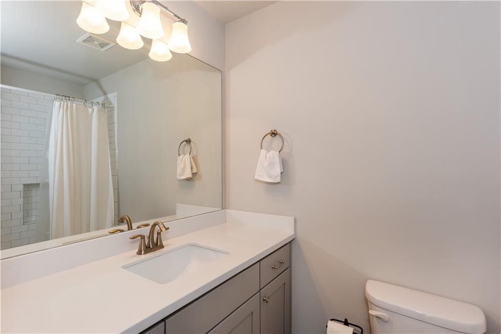 5247 Cresslyn Ridge Alpharetta, GA 30005 - Photo 36 of 38 a bathroom with a sink vanity and a mirror