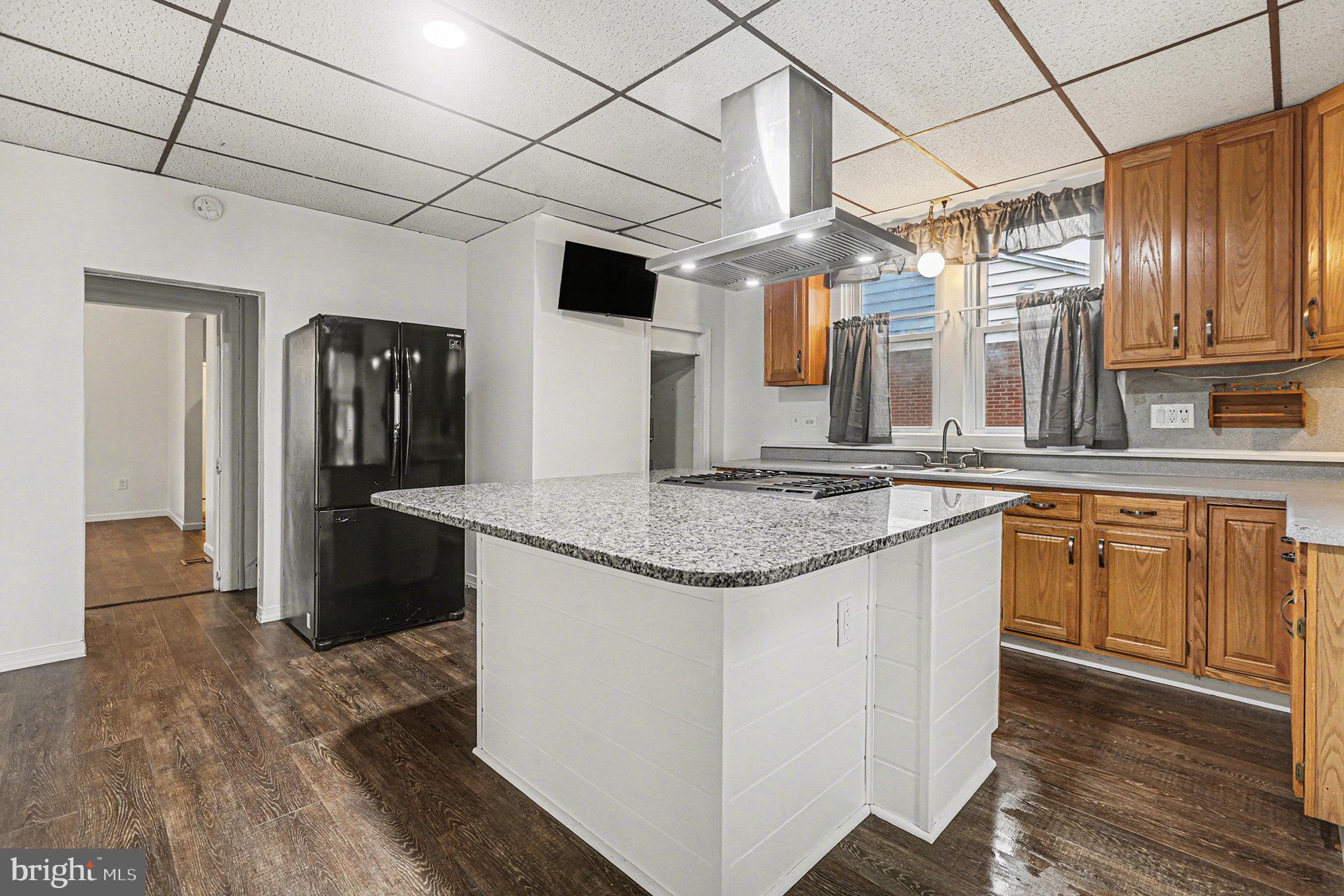 458 Highland Street Harrisburg, PA 17113 - Photo 13 of 31 a kitchen with stainless steel appliances granite countertop a sink and refrigerator