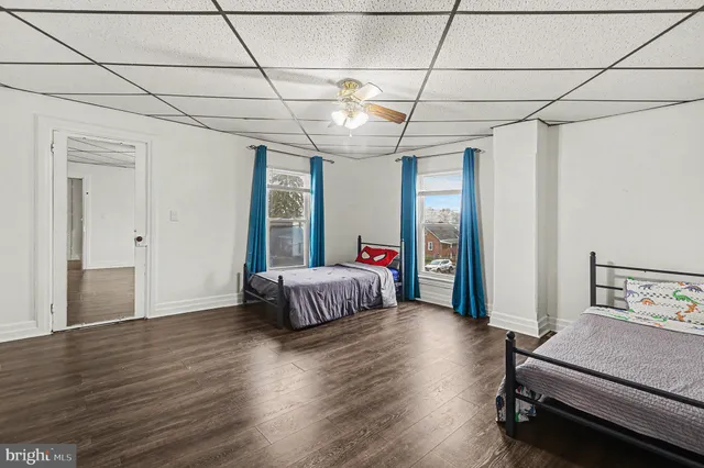 a spacious bedroom with a bed and a chandelier