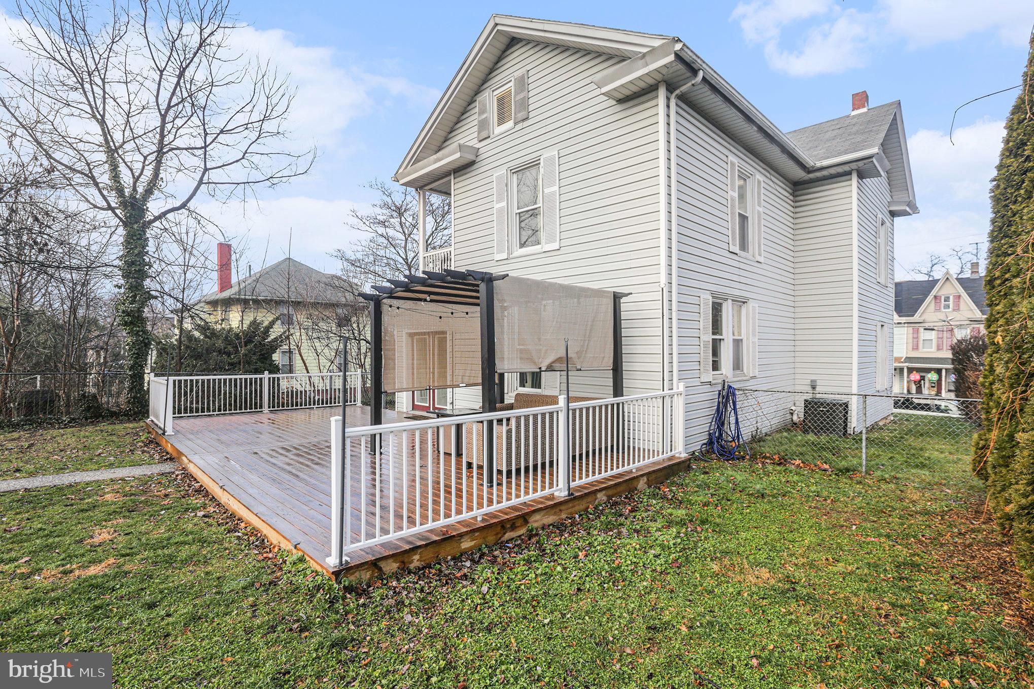 458 Highland Street Harrisburg, PA 17113 - Photo 26 of 31 a view of a house with a yard and a wooden deck
