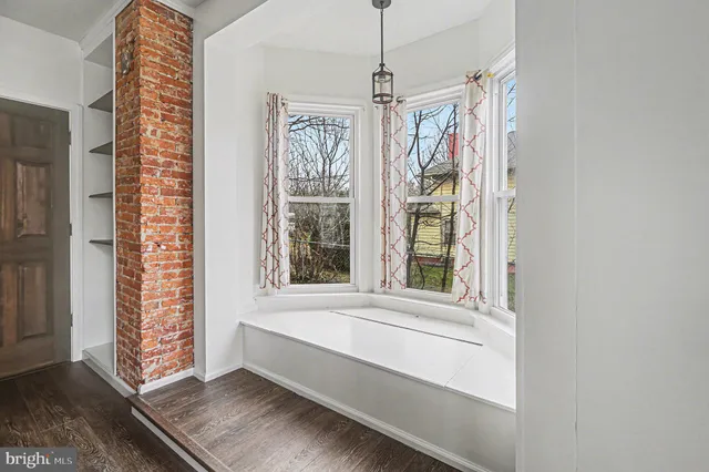 a view of room with window and hardwood floor