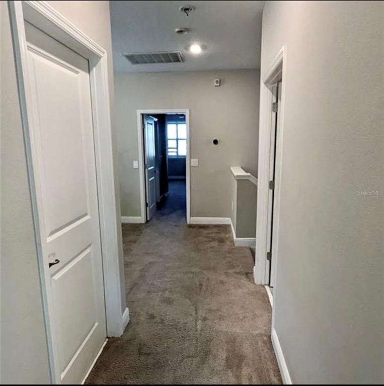 8582 Powder Ridge Trail Windermere, FL 34786 - Photo 11 of 37 a view of a hallway with wooden shelves