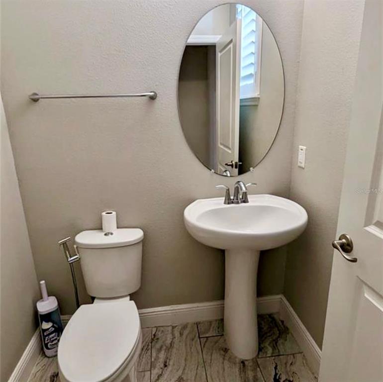 8582 Powder Ridge Trail Windermere, FL 34786 - Photo 12 of 37 a bathroom with a toilet sink and mirror