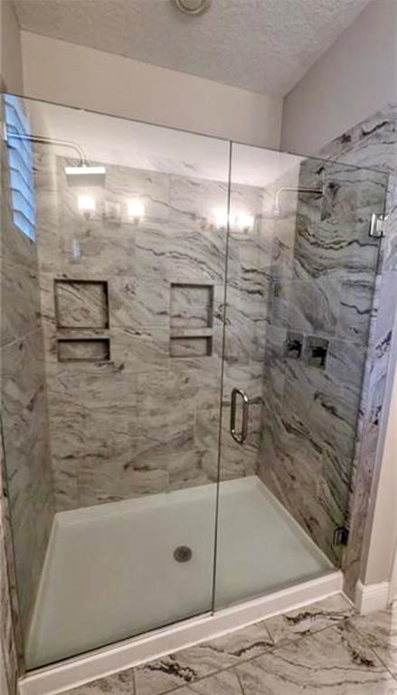 8582 Powder Ridge Trail Windermere, FL 34786 - Photo 15 of 37 a bathroom with bathtub and shower