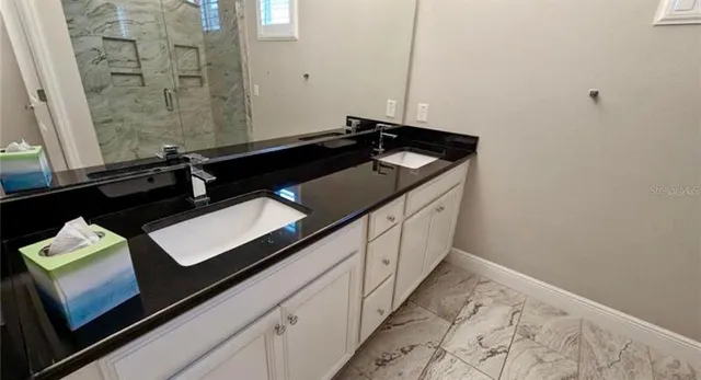 a bathroom with a sink and a mirror
