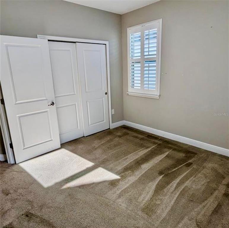 8582 Powder Ridge Trail Windermere, FL 34786 - Photo 21 of 37 a view of a room with a white bed & cabinets