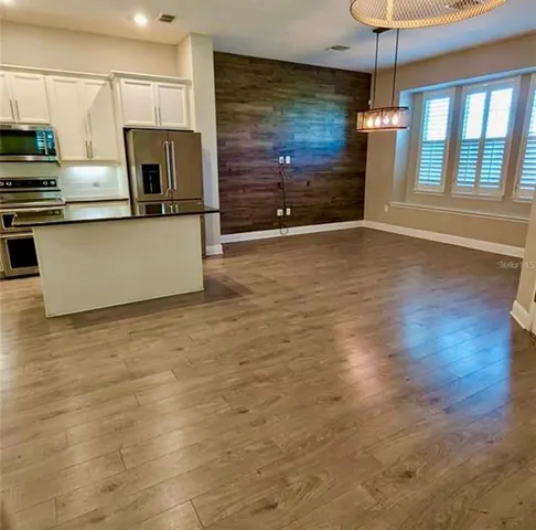 a view of a kitchen with a sink microwave and cabinets