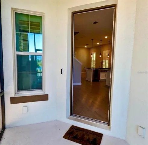 a view of a hallway with a glass door and a window