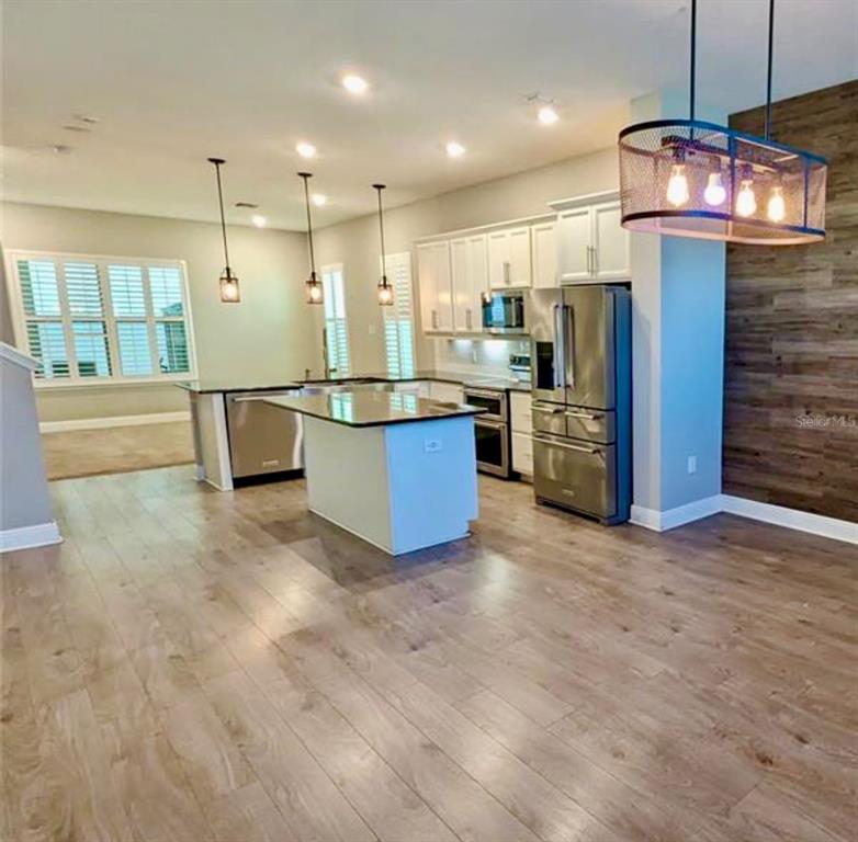 8582 Powder Ridge Trail Windermere, FL 34786 - Photo 6 of 37 a view of kitchen with stainless steel appliances refrigerator stove microwave and cabinets